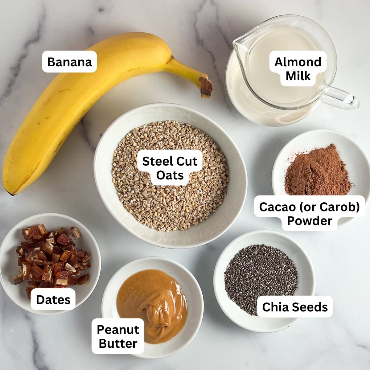 Ingredients for chocolate peanut butter oatmeal: steel cut oats, almond milk, cacao powder, chia seeds, peanut butter, dates, banana.