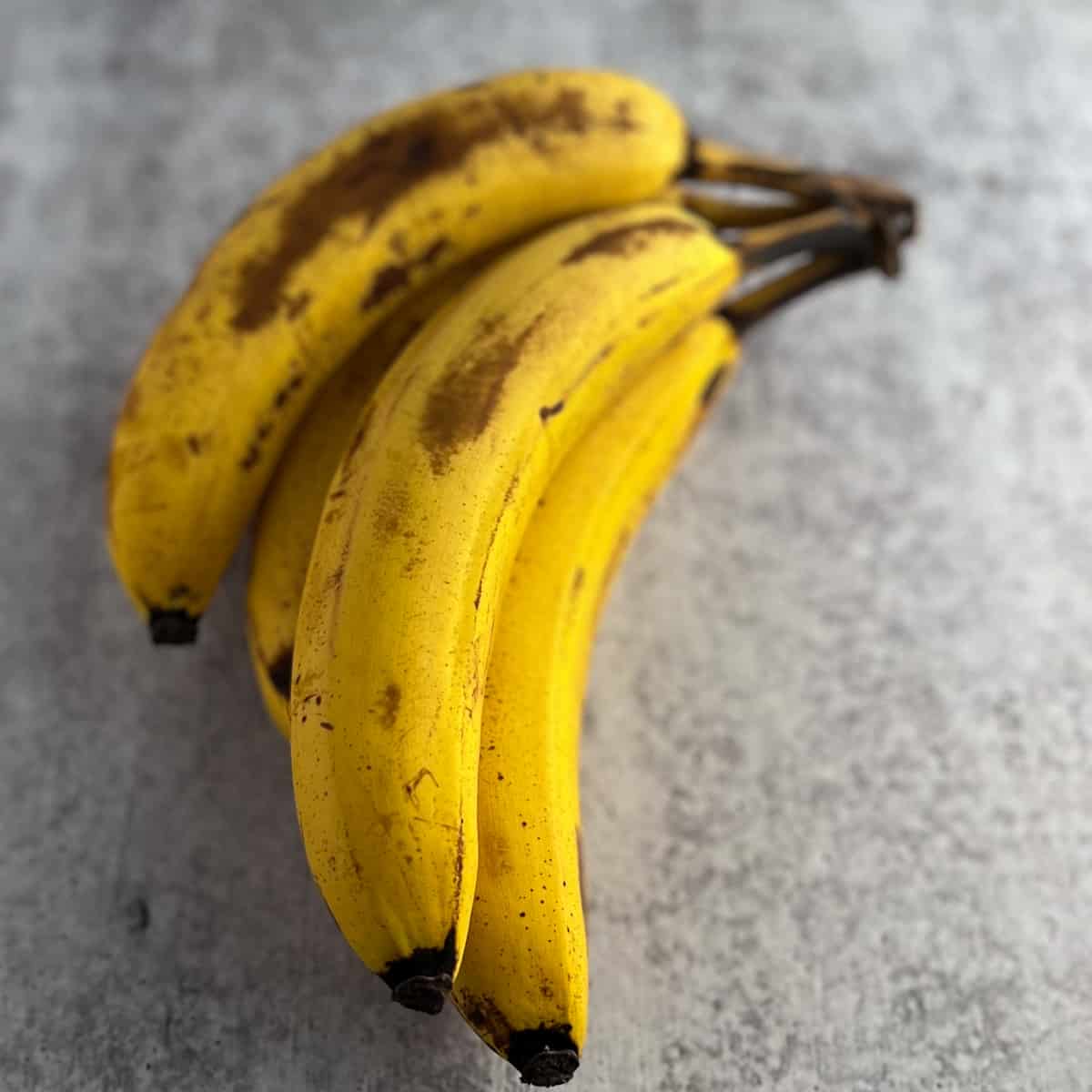 top view of ripe bananas on a grey surface