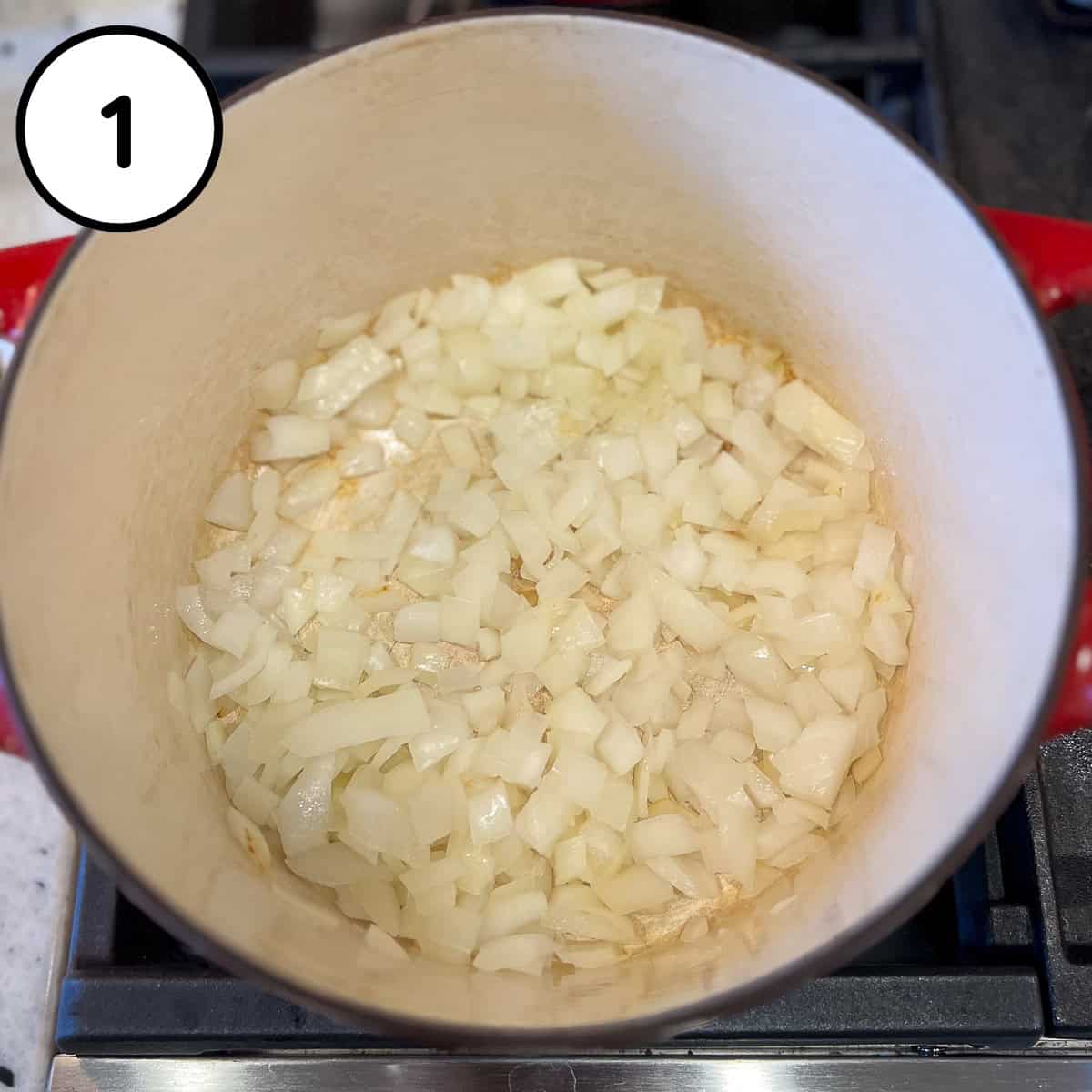 Chopped onions sauteing in a pot.
