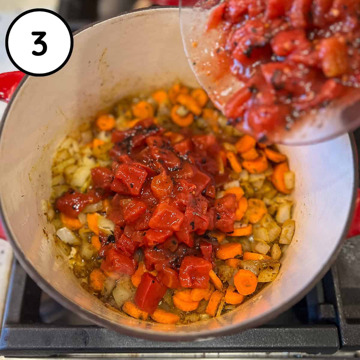 Fire roasted diced tomatoes being added to the pot.