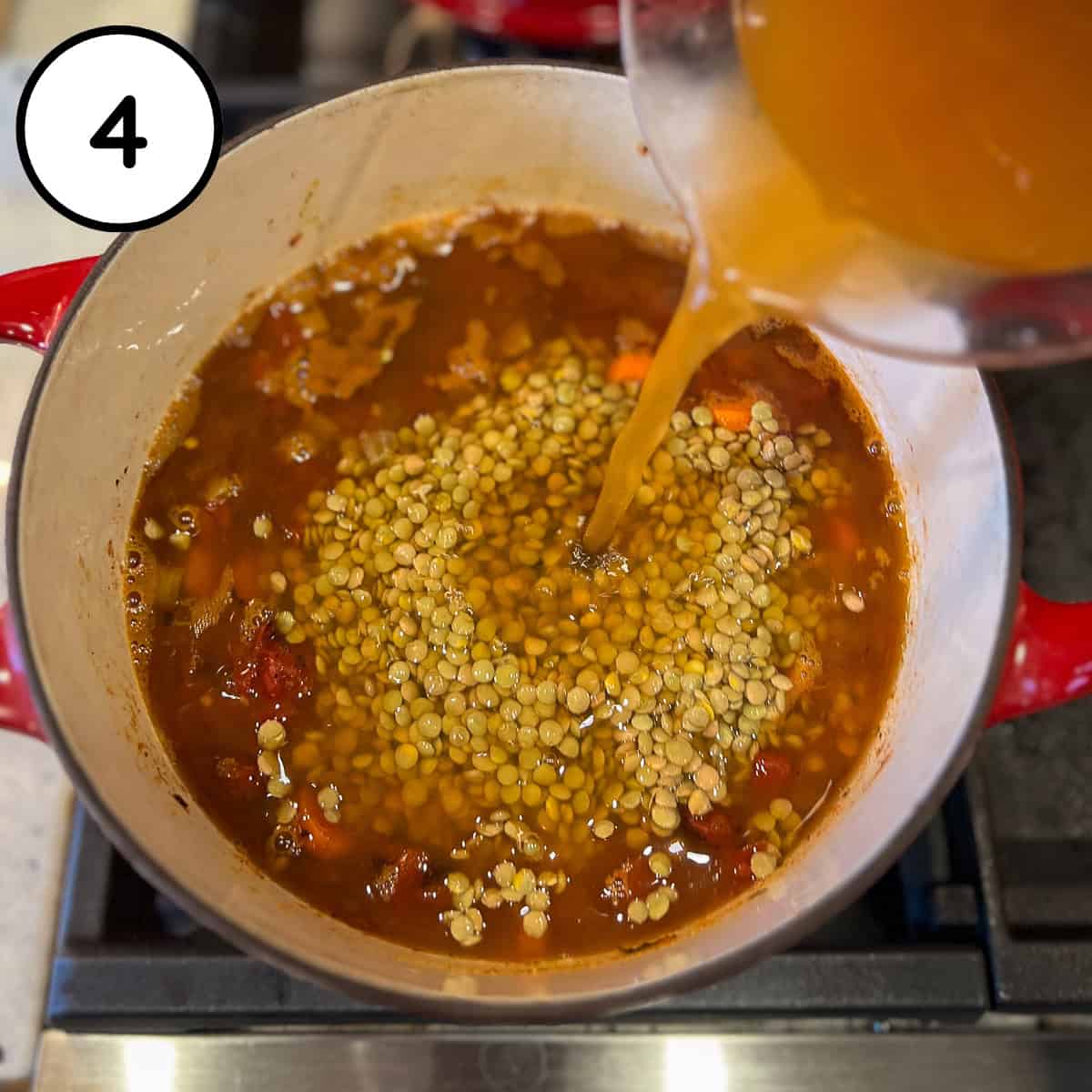 Lentils and vegetable broth being added to the pot.