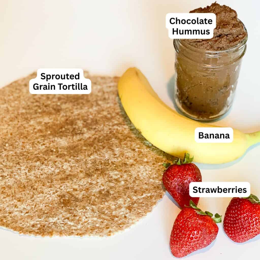 Ingredients for chocolate hummus breakfast wrap: sprouted grain tortilla, chocolate hummus, banana and strawberries.