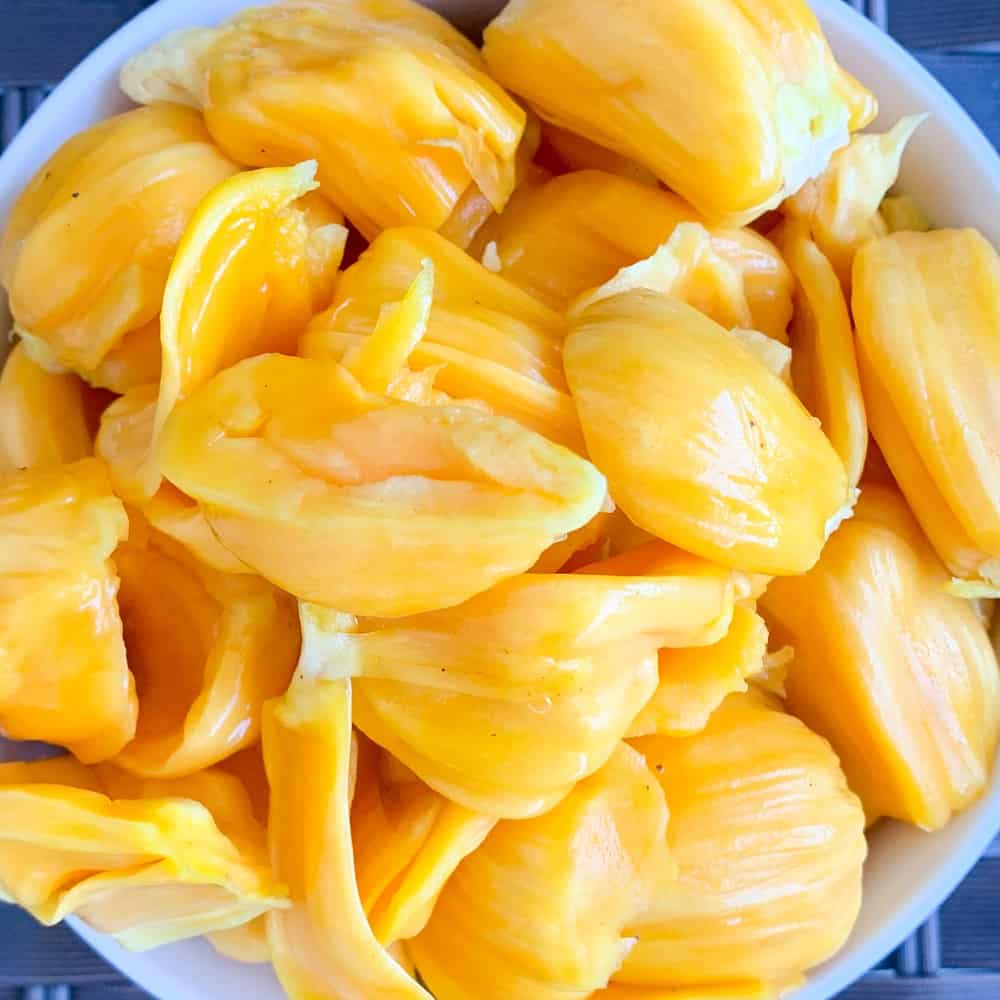 top close up view of ripe jackfruit flesh in a white bowl to be used in the sweet and sassy jackfruit salsa.