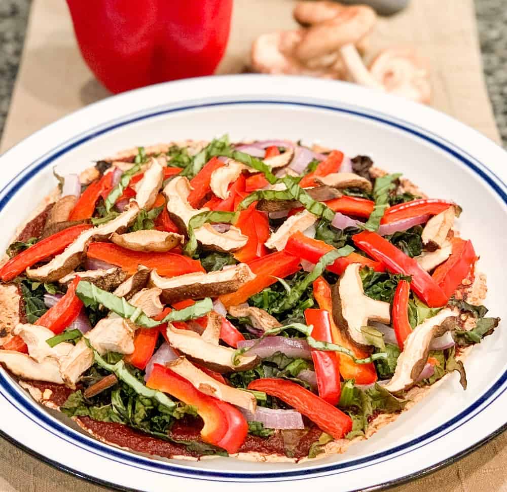 Thin crust veggie pizza topped with mushrooms, bell pepper, fresh basil, fresh spinach.