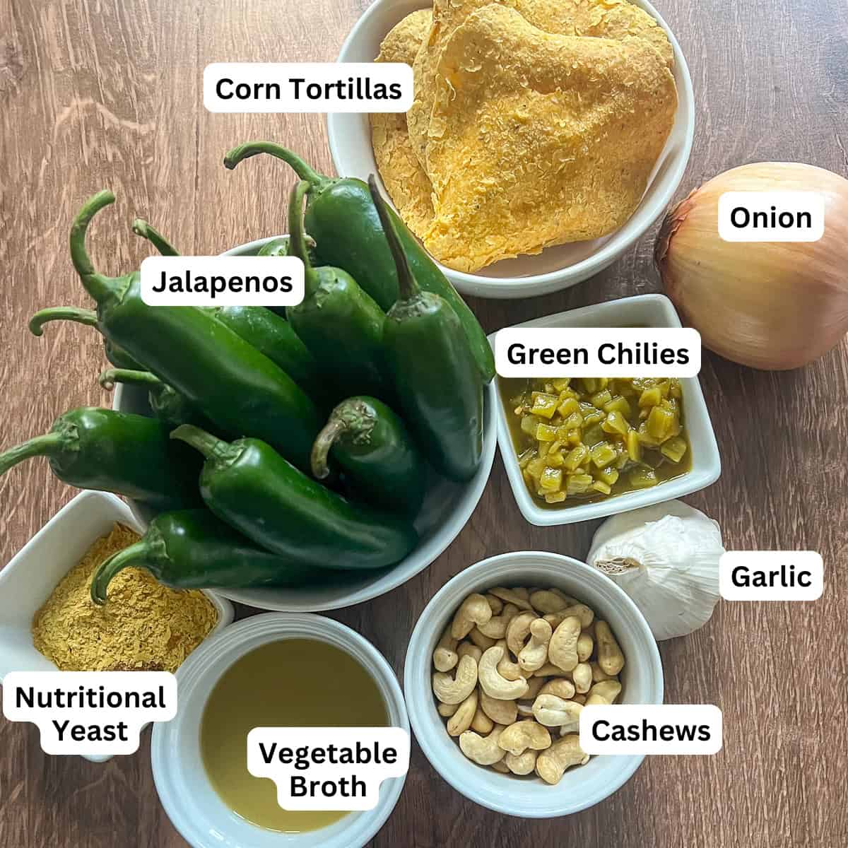 Ingredients for vegan jalapeno poppers: jalapenos, corn tortillas, green chilies, onion, garlic, cashews, nutritional yeast and seasonings.