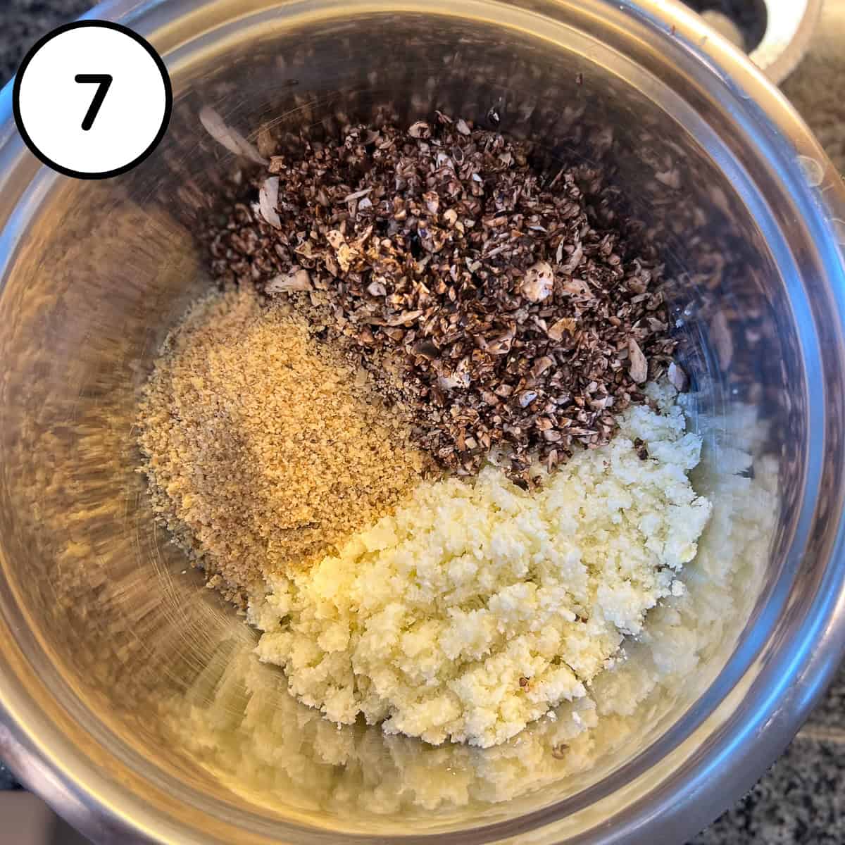 Processed cauliflower, walnuts and mushrooms in a large mixing bowl.