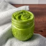 Avocado cilantro lime dressing in an open mason jar.