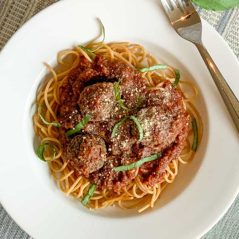top view of bowl of spaghetti with vegan meatballs with sauce