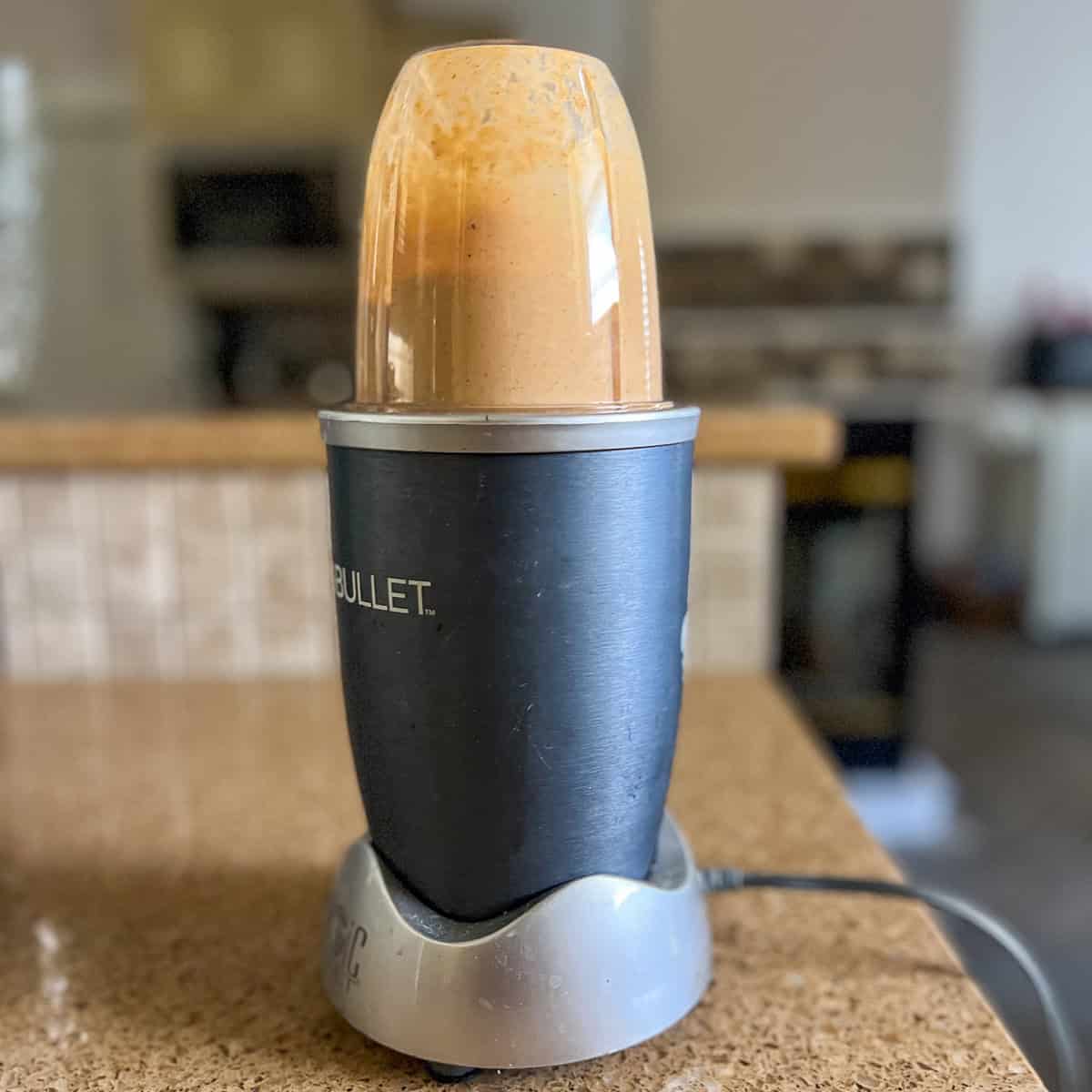 Spicy chipotle cream sauce being blended in a mini blender.