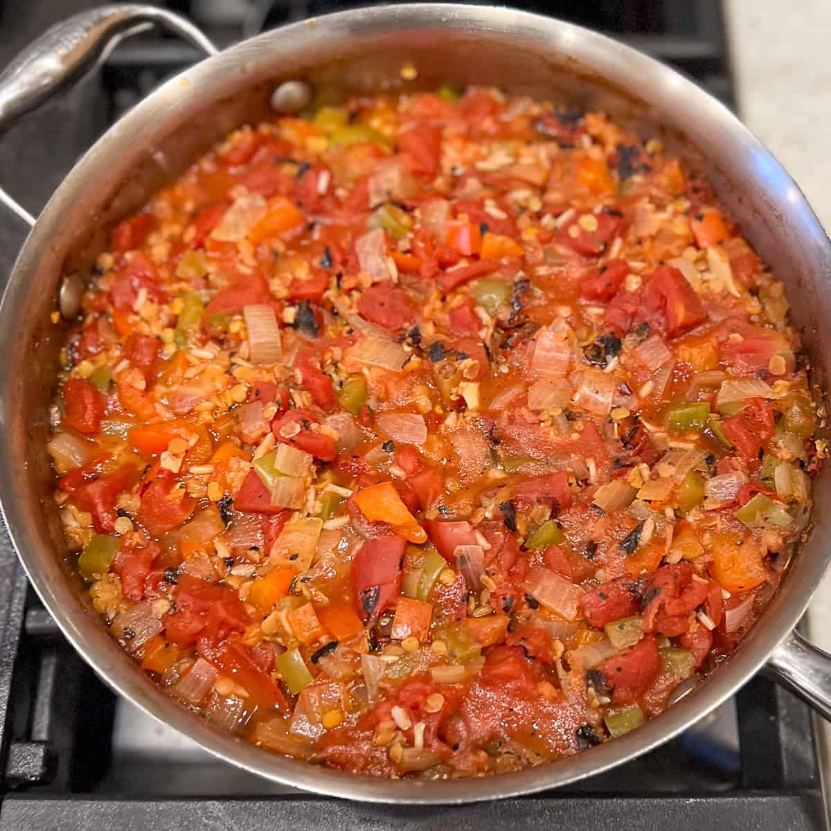 Deconstructed stuffed peppers in a sauté pan after cooking.