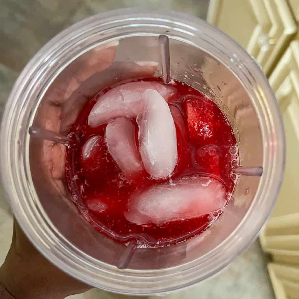 Copycat Starbucks pink drink ingredients in a blender cup.