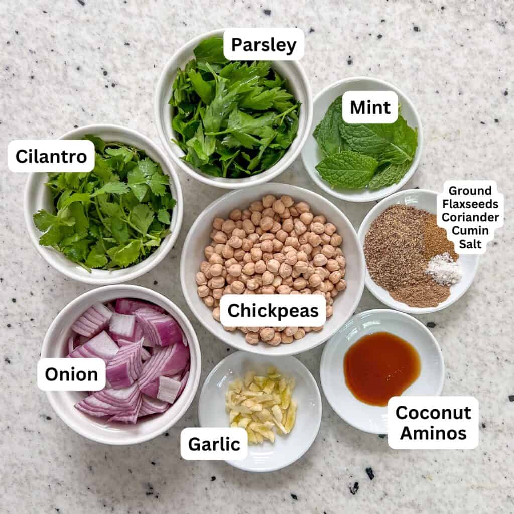 The ingredients for air fryer falafels: chickpeas, onion, garlic, herbs and spices.