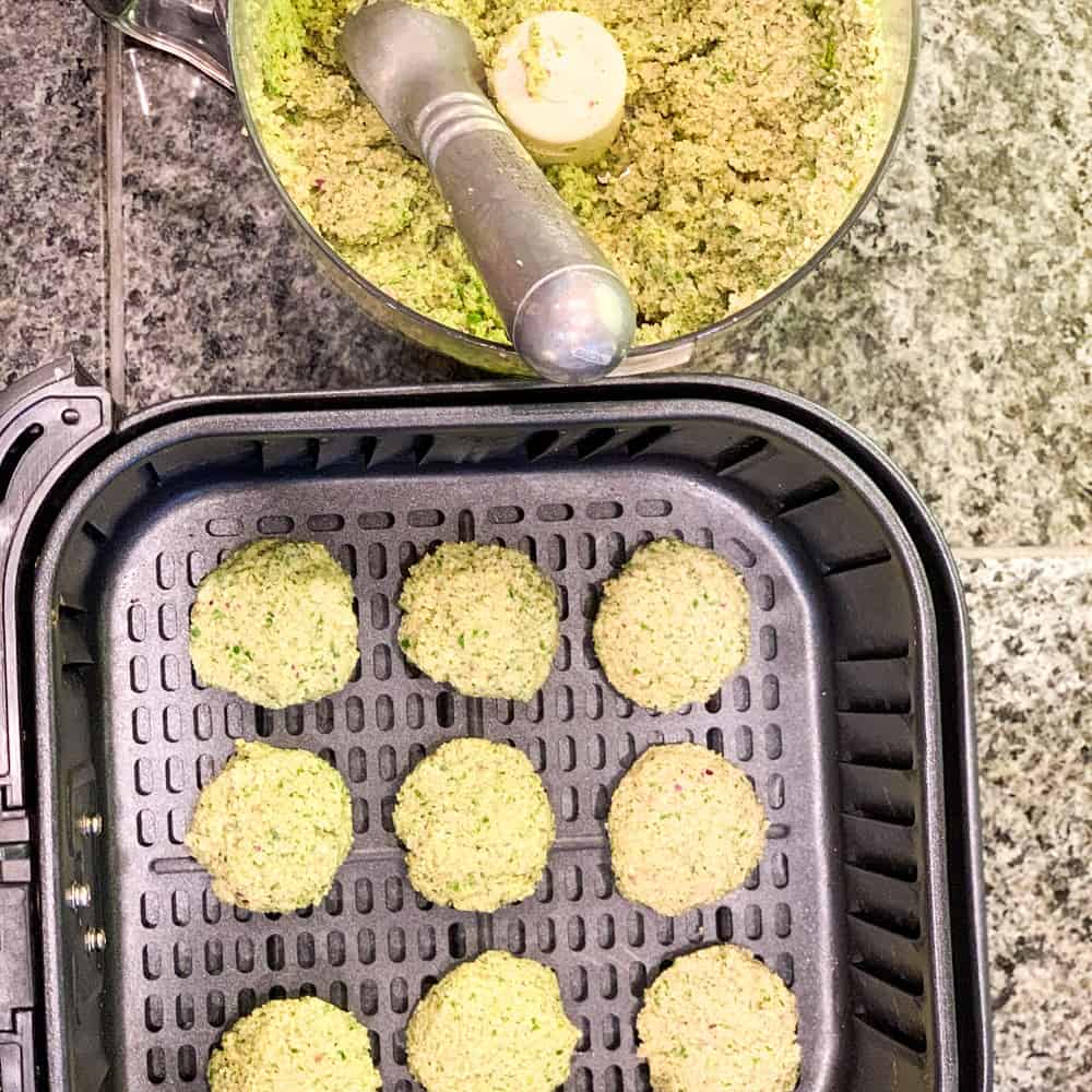 top view of patties in an air fryer for The Best Falafel That Happens to be OIL-FREE