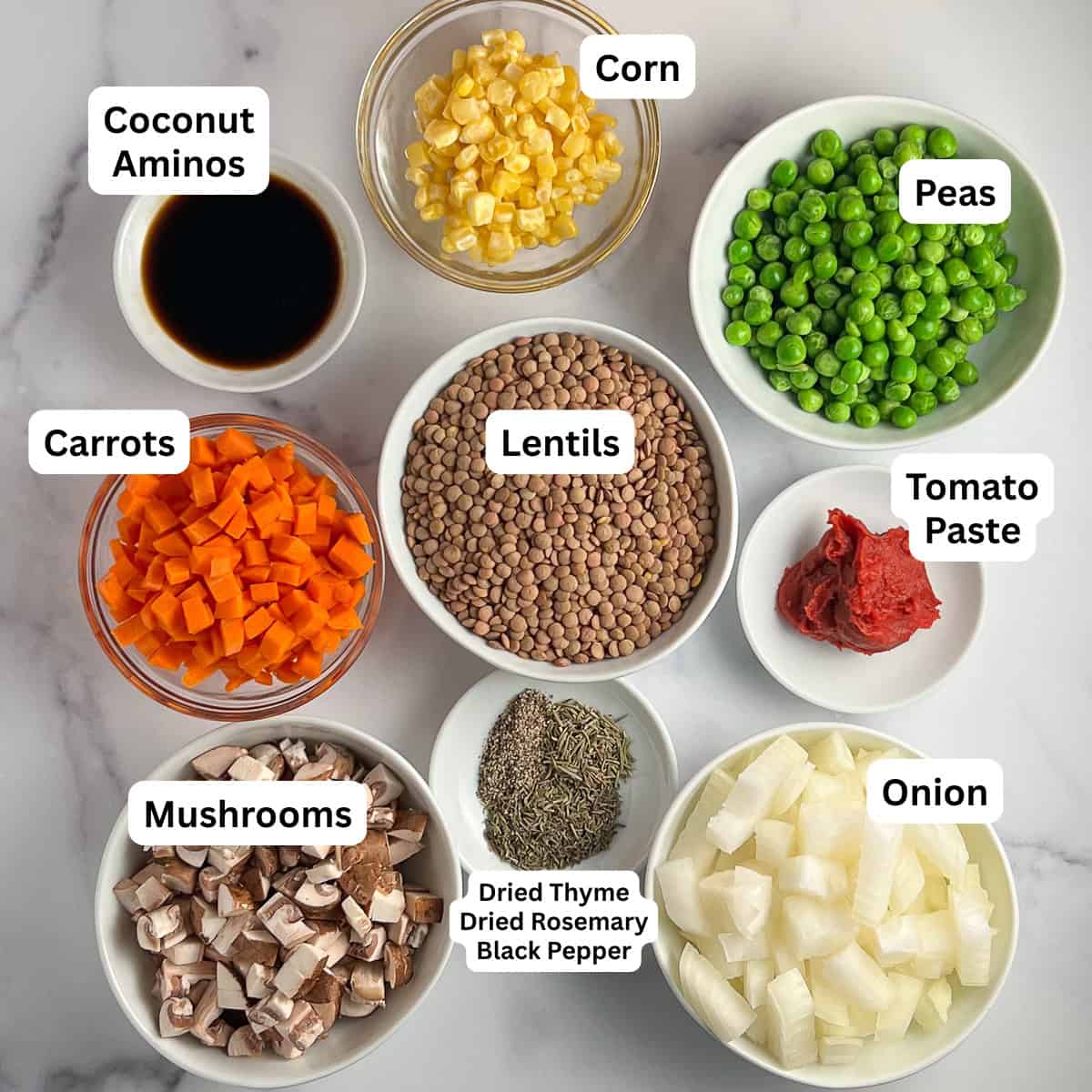 Ingredients for vegan shepherd's pie: lentils, peas, corn, carrots, onion, mushrooms, tomato paste, and seasonings.