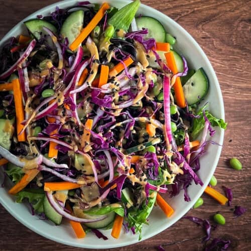 Asian noodle salad loaded with colorful vegetables in a bowl.