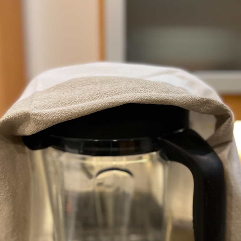 side view of a towel loosely covering the blender lid