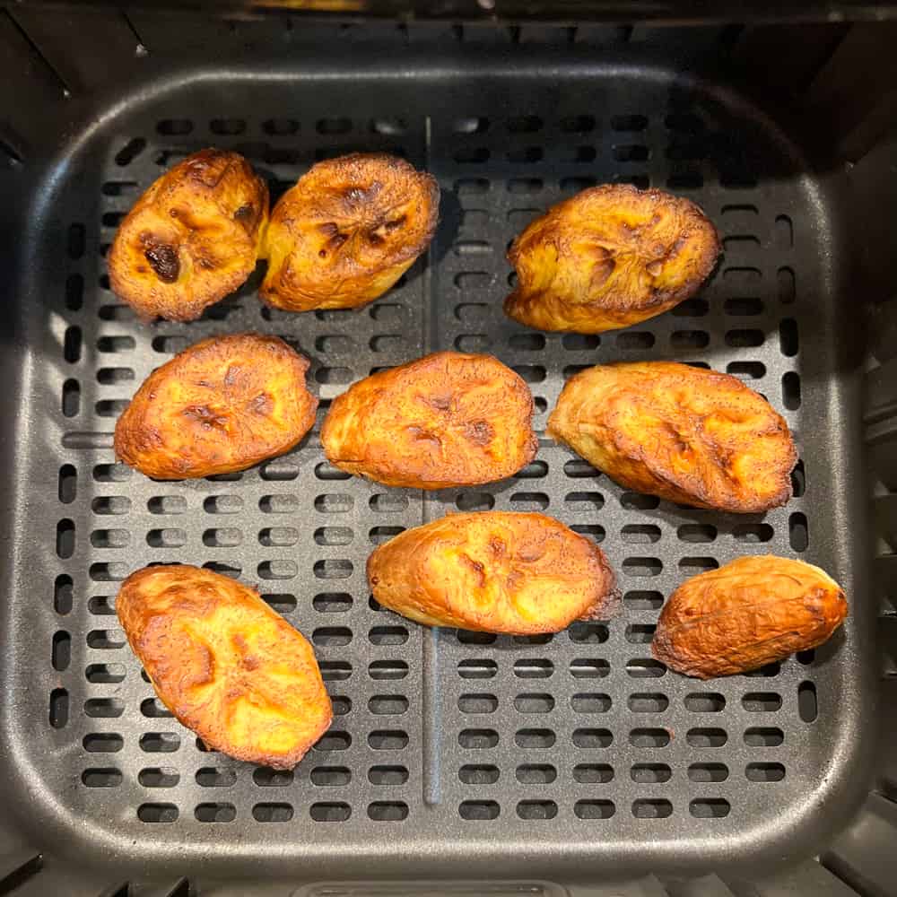 cooked plantain slices in the air fryer basket