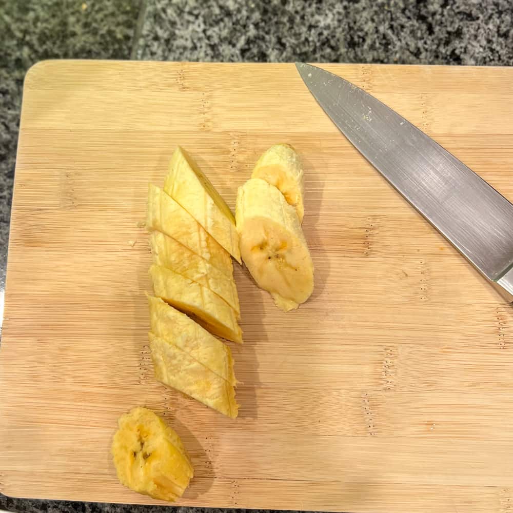 a plantain that has been cut at an angle into slices