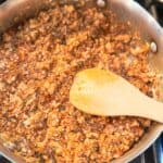 Sofritas in a skillet with wooden spoon.