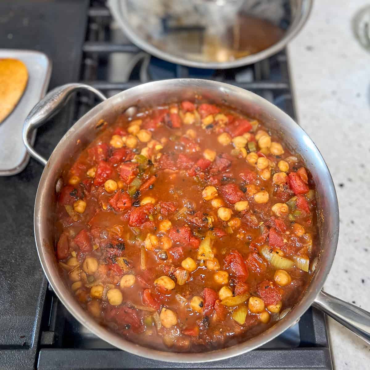 Vegan chana masala simmering in the sauté pan.