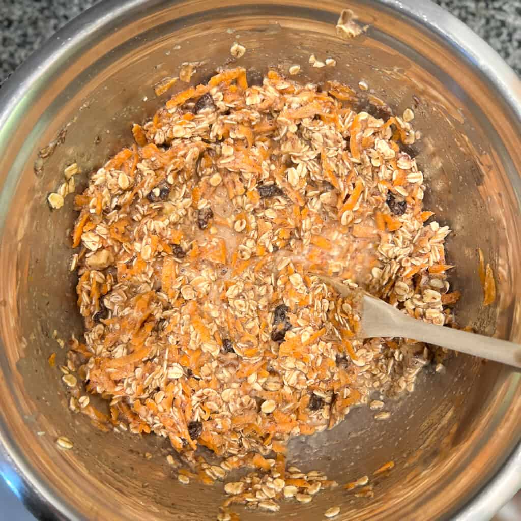 top view close up of carrot cake baked oatmeal ingredients combined in a large mixing bowl