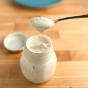 top side view of vegan mayo in a glass jar with spoon
