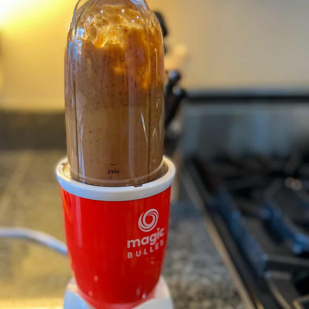 blended homemade date syrup in a red mini blender