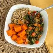 top view close up of peanut butter greens, sorghum and sweet potato in a white bowl with fork