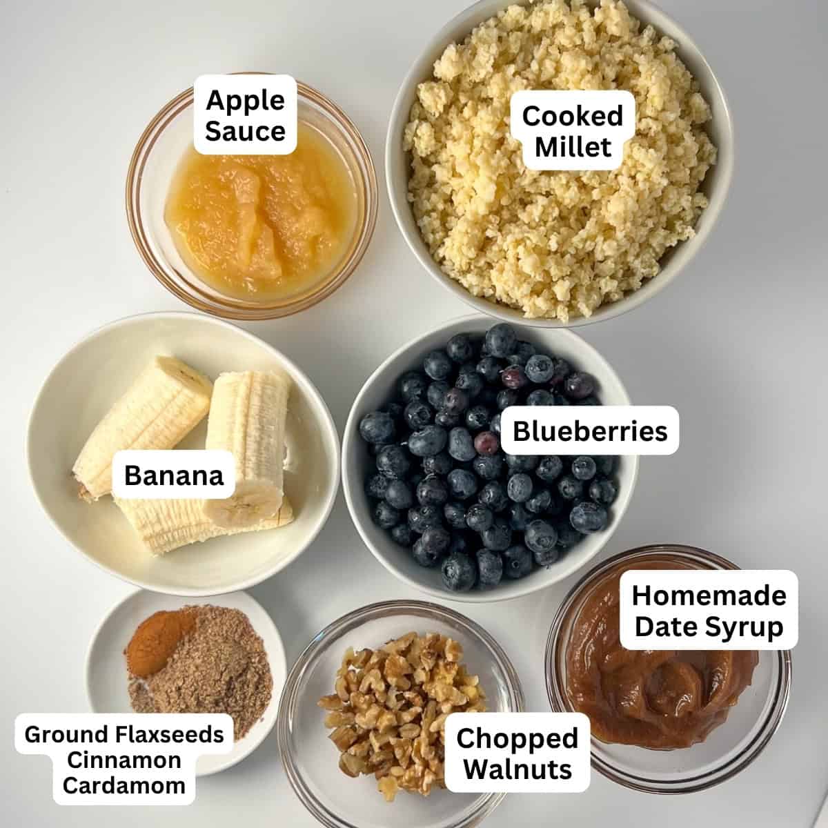 Millet muffin ingredients: unsweetened apple sauce, millet (cook and cooled), banana, fresh blueberries, ground flaxseeds, cinnamon, cardamom, simple homemade date syrup, and chopped walnuts.