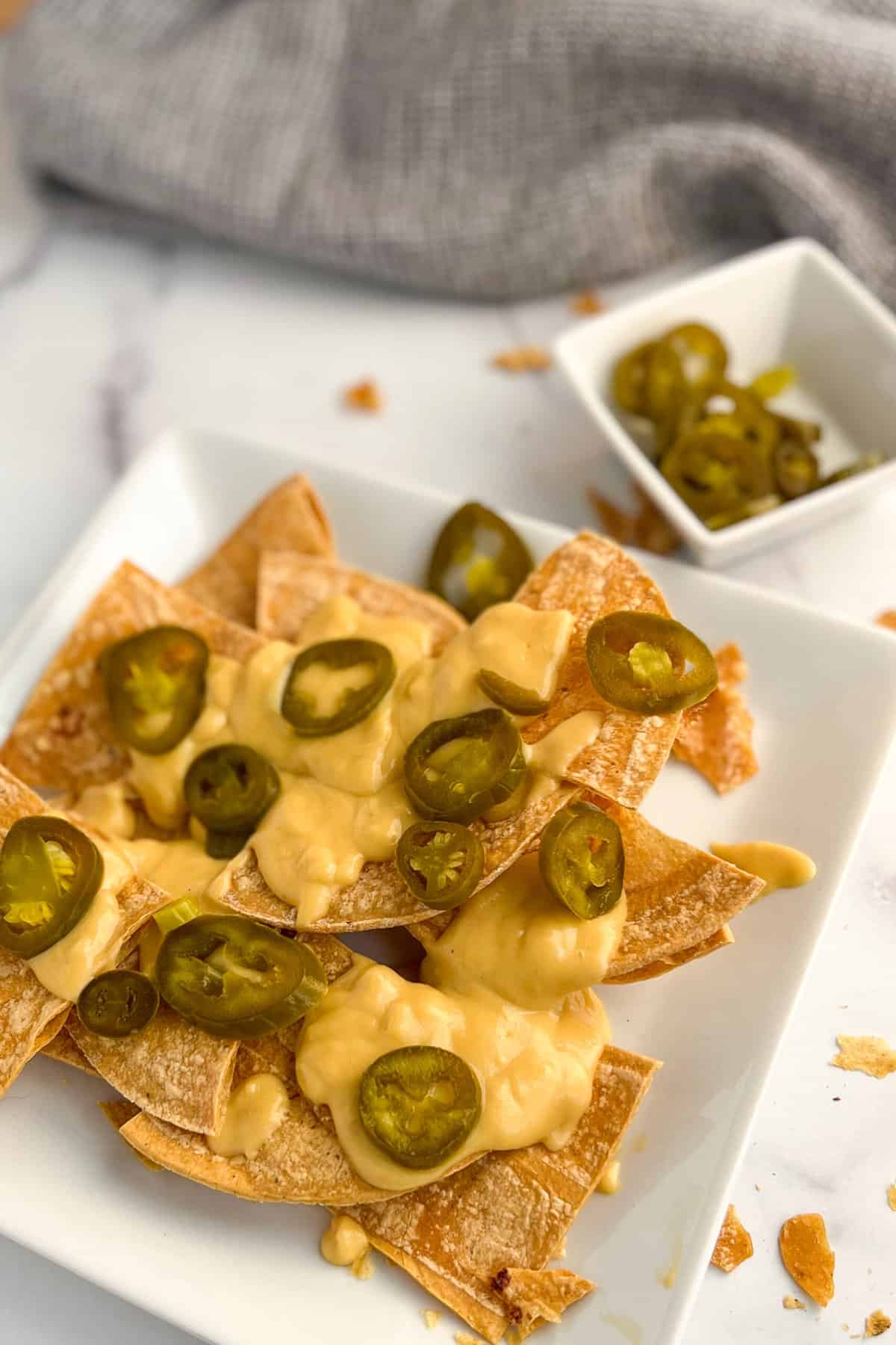 top side view of vegan nachos on a square white plate