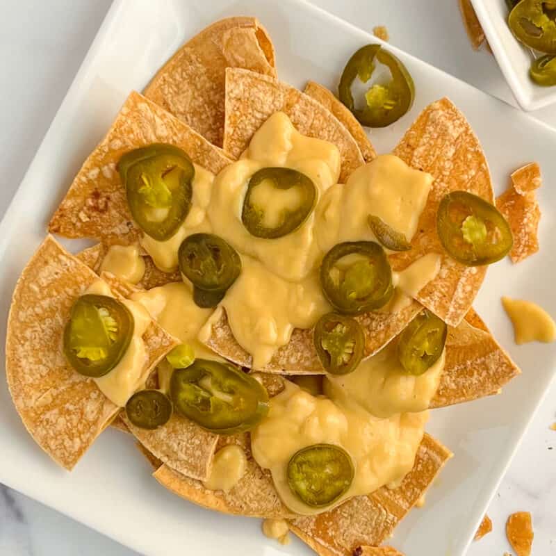 top view of vegan nachos on a white square plate