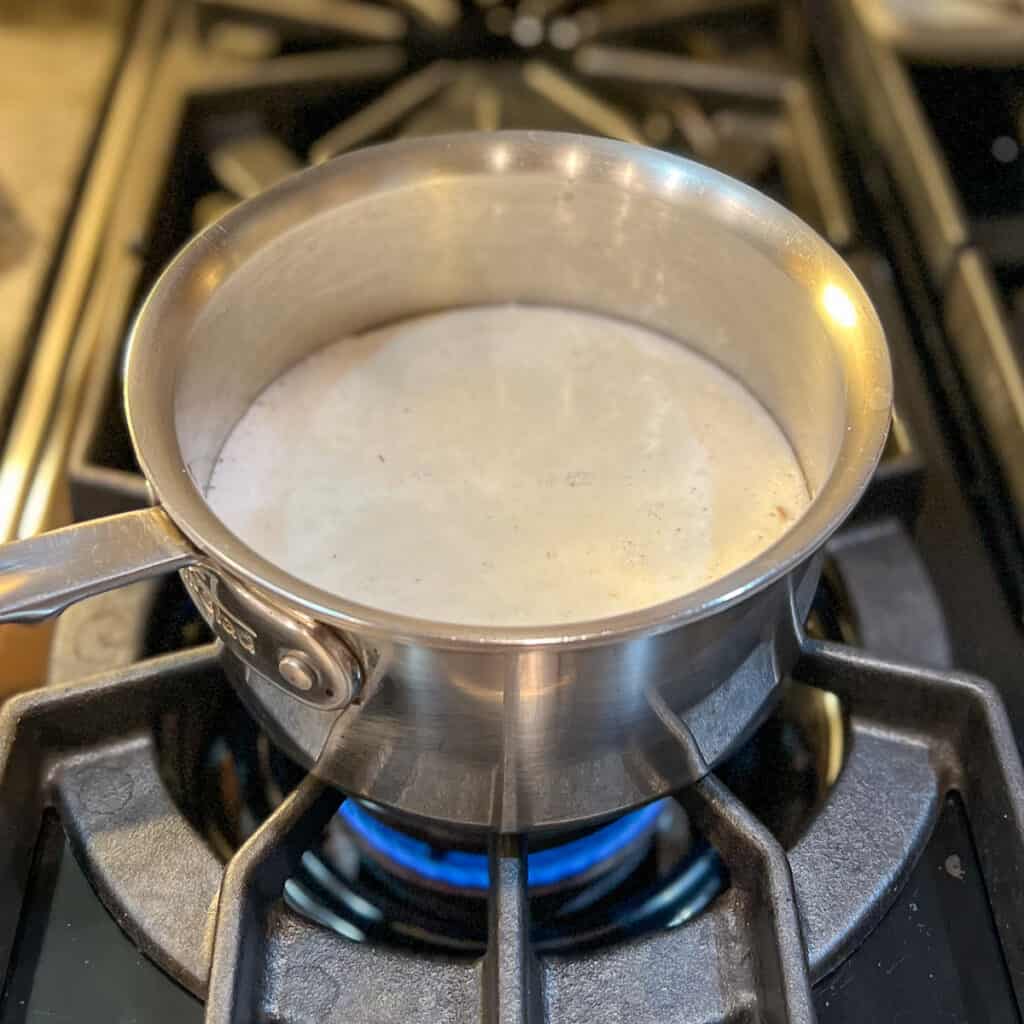 Steel cut oats cooking in a pot with water.