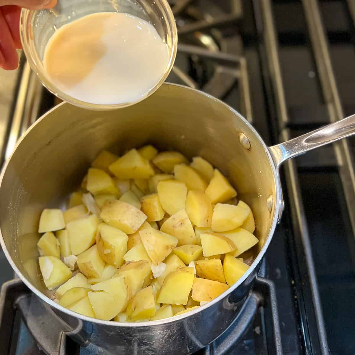 soymilk being added to cooked potatoes