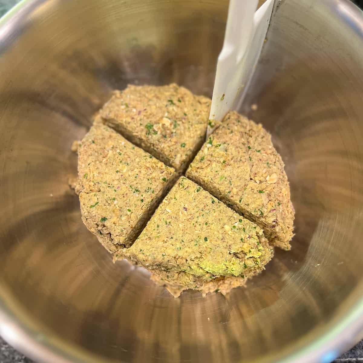 top view of chickpea patty mixture being divided into four parts