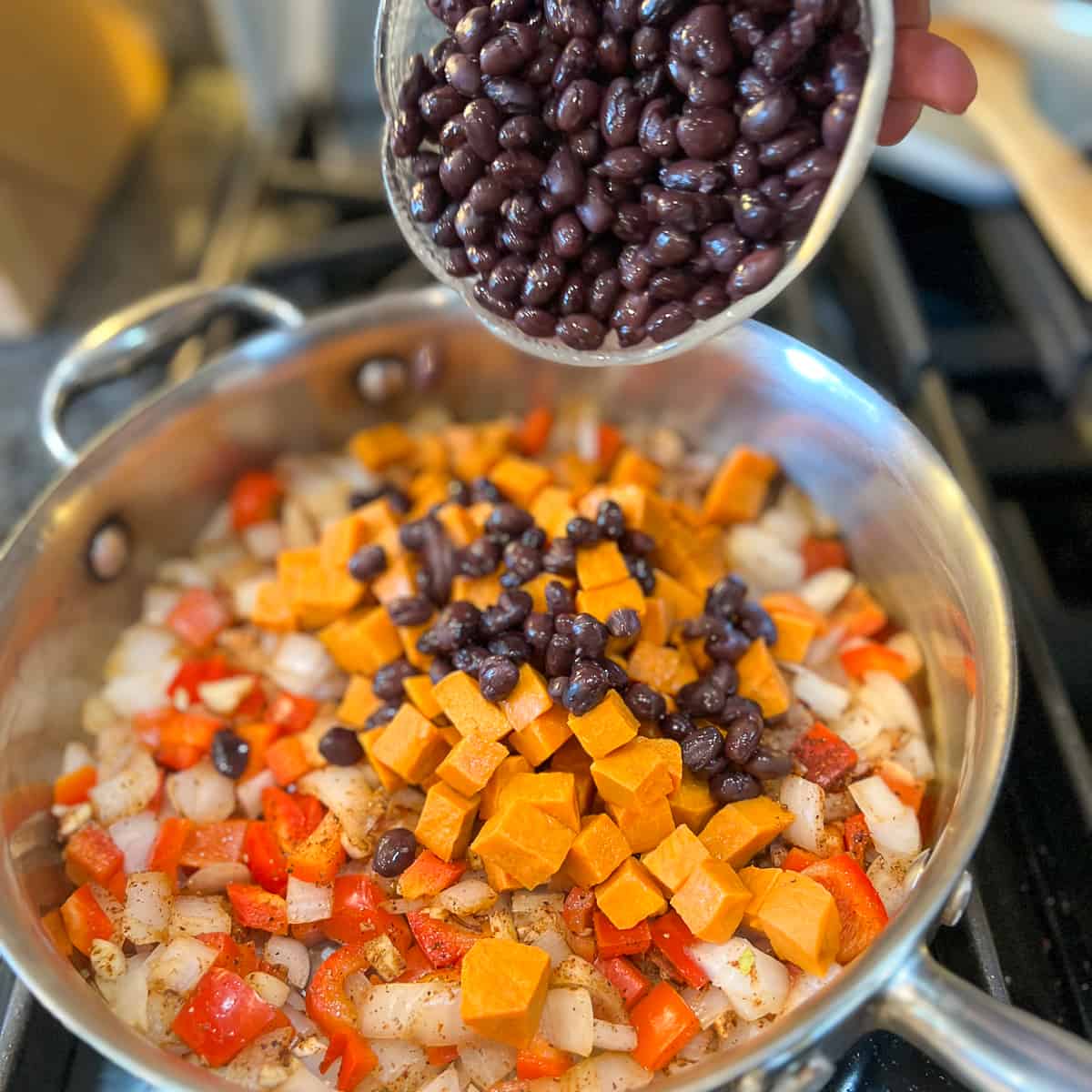black beans and sweet potato added to the pan with other veggies