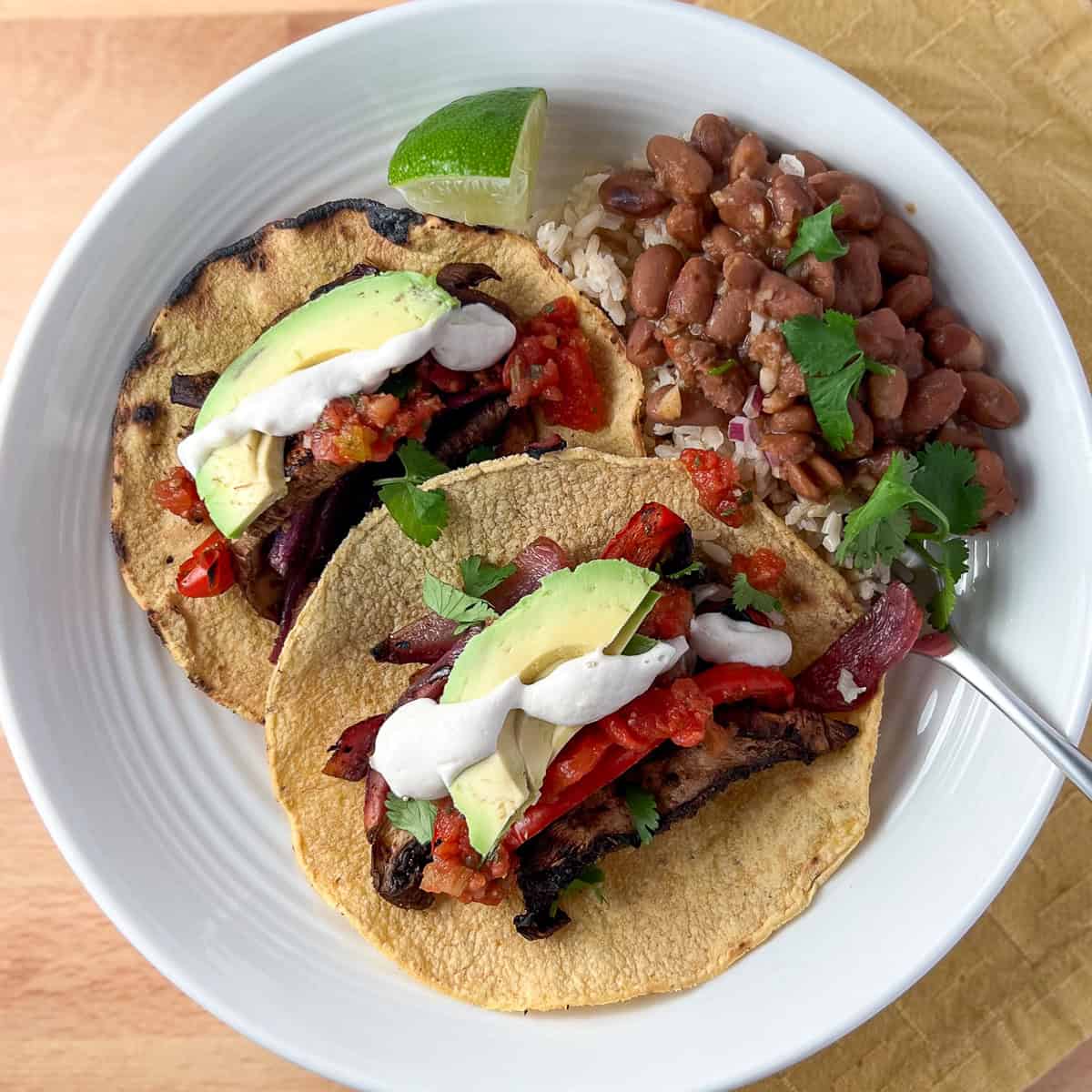 Vegan fajitas with a side of beans and rice.