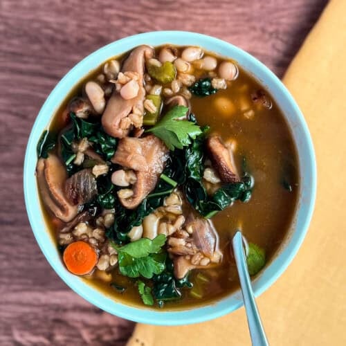 Mushroom barley soup in a bowl with a spoon.