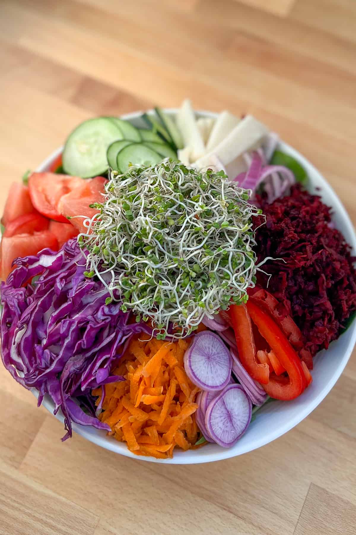 top view close up of a large salad with a rainbow of veggies in a bowl