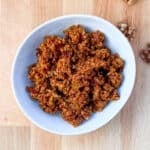 top view close up of vegan taco walnut meat in a white bowl; scatter walnut pieces on side