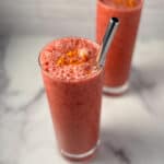 top side view of plum smoothie with metal straw