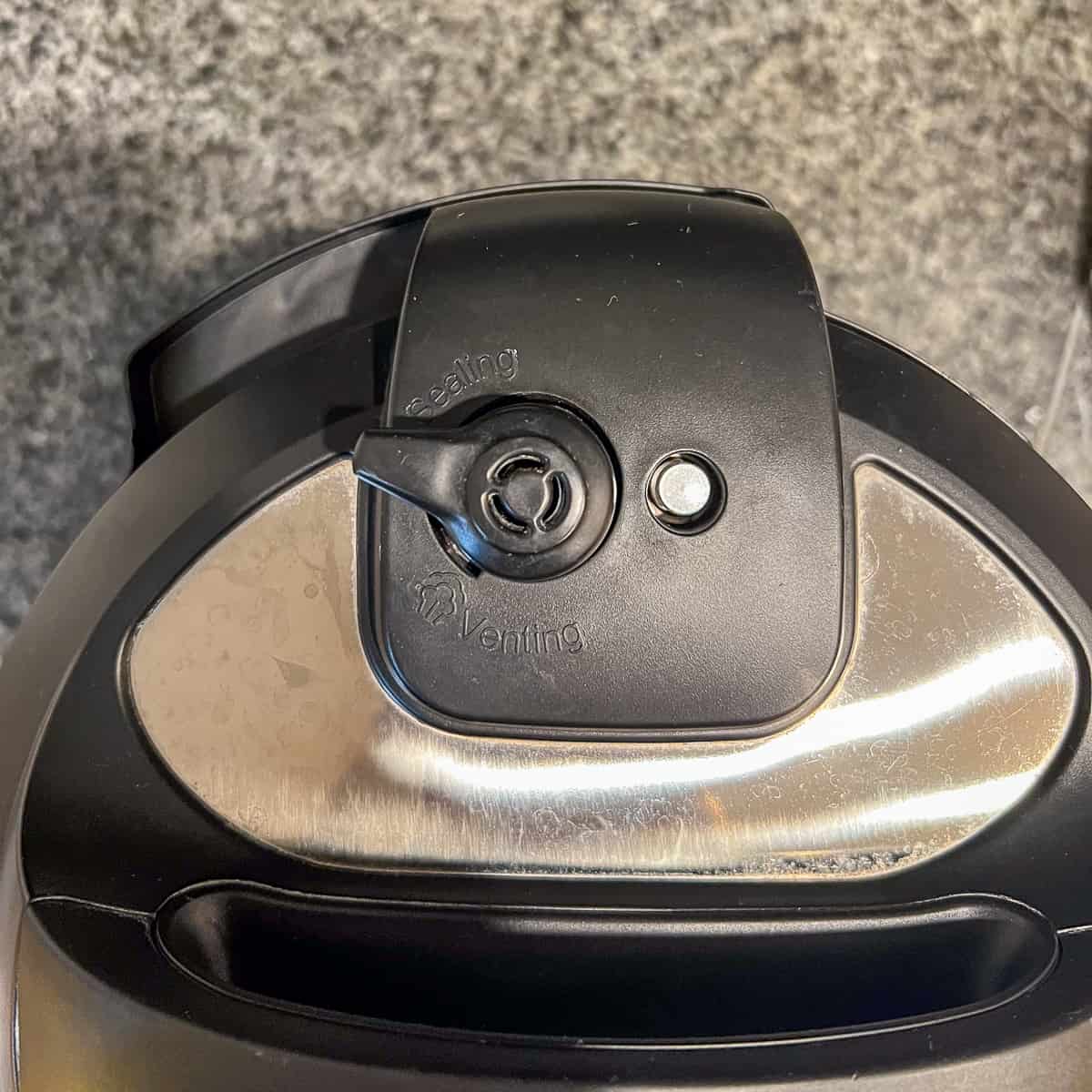 top view of the Instant Pot lid with the valve in the "Sealing" position