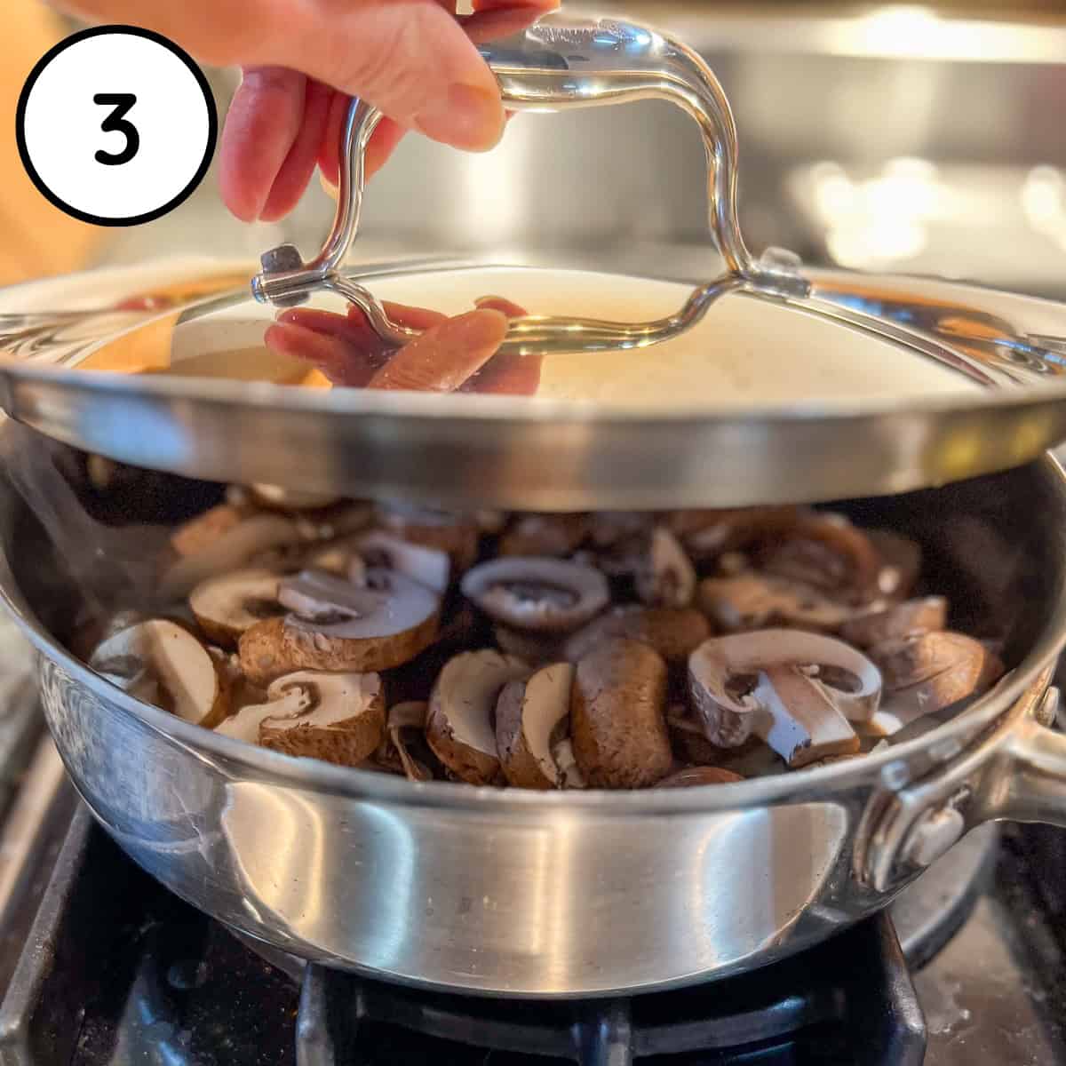 Lid being added to the pan with mushrooms and onions.