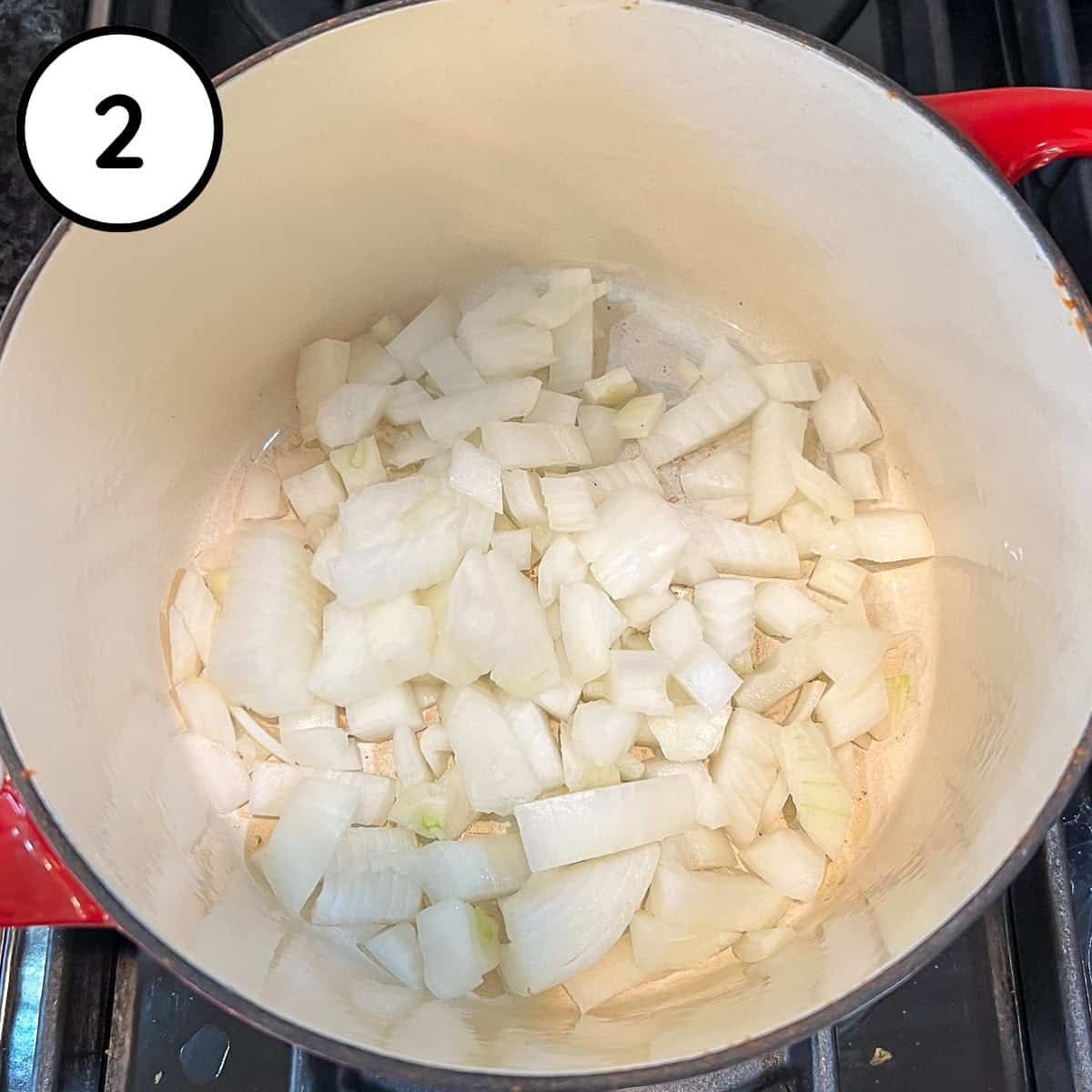 Chopped onions sautéing in a pot.