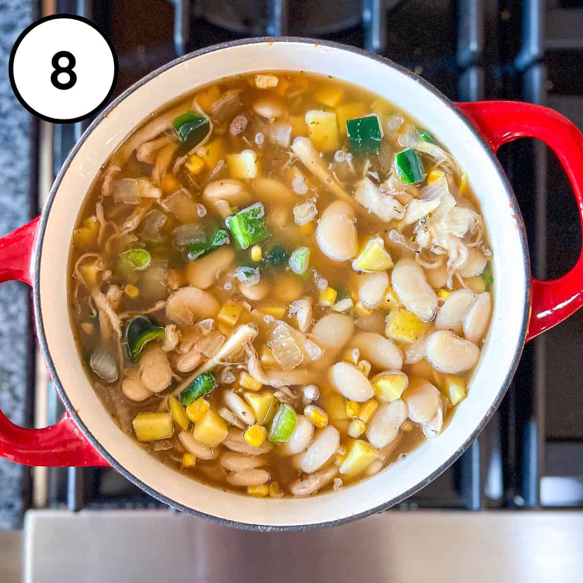 Vegan white bean chili on the stove cooking.
