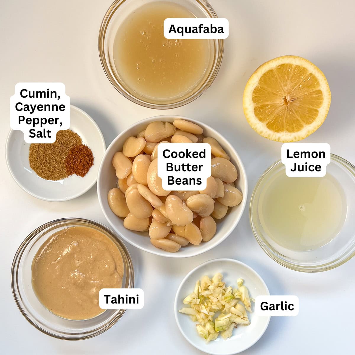 The ingredients for butter bean hummus: butter beans, lemon, garlic, tahini, spices.