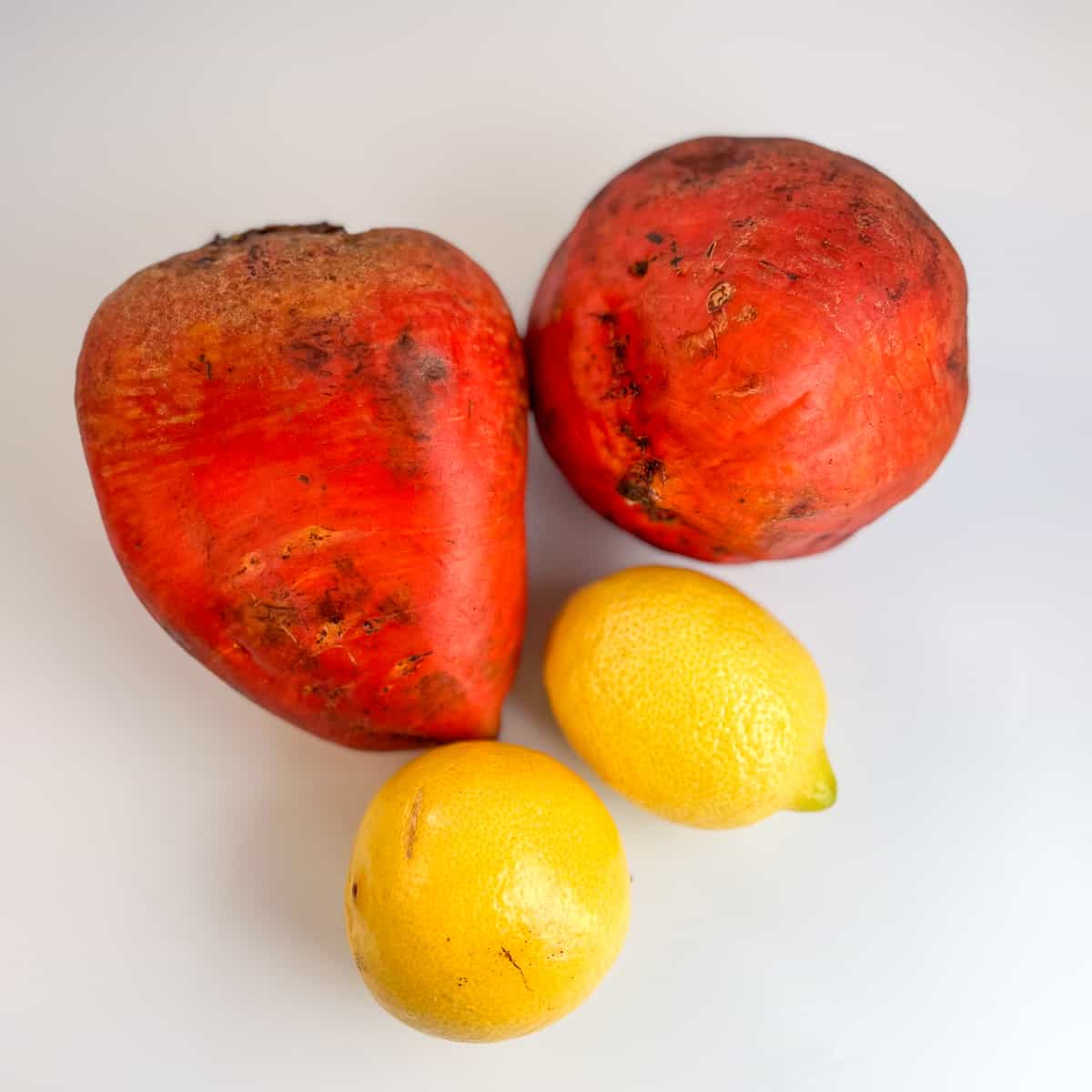 Two golden beets and two lemons.