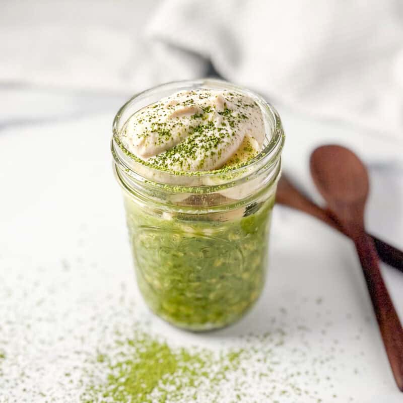 Matcha overnight oats topped with sweet cashew cream and dusting of matcha powder.