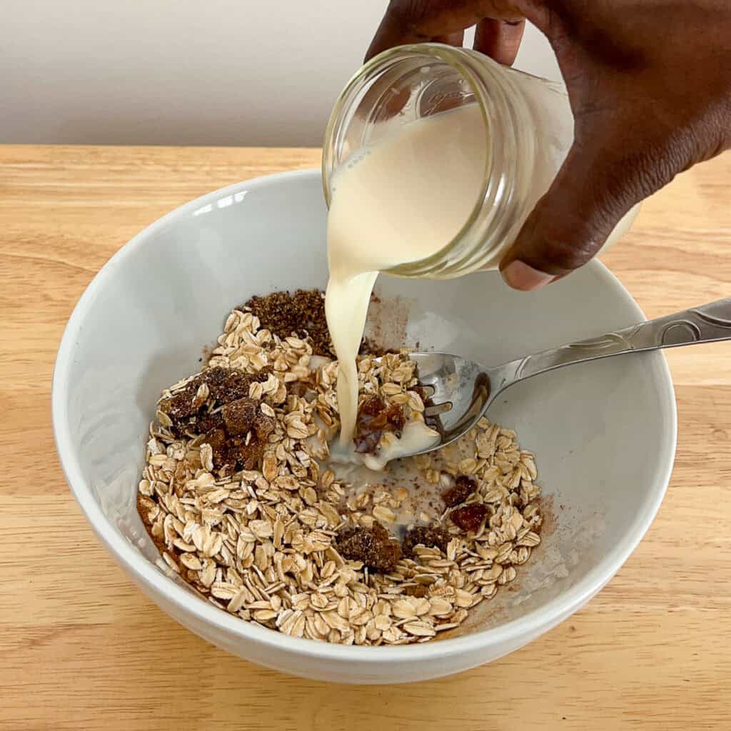 Plant based milk being poured into the oat mixture.