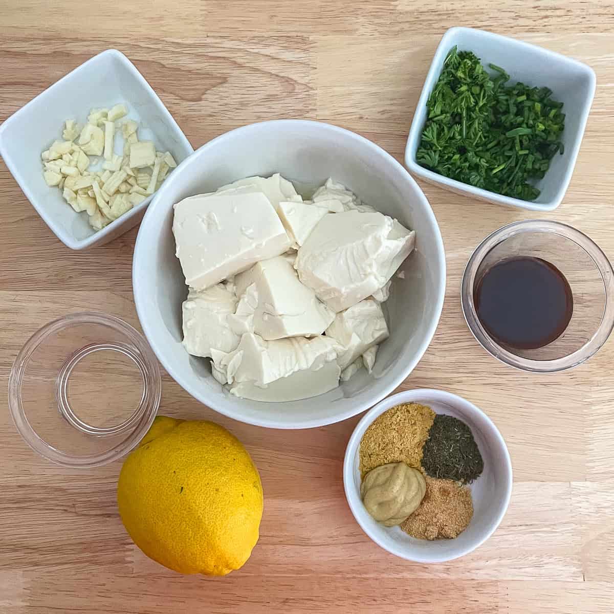 Ingredients for vegan ranch dressing: silken tofu, lemon, garlic, Dijon mustard, herbs and spices.