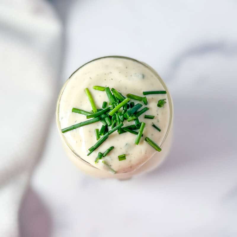 Vegan ranch dressing with chopped chives.